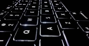 A close up into an illuminated computer keyboard; cybersecurity