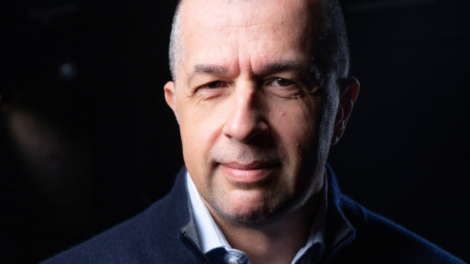 A portrait photo of Dan Mihaescu on a black background
