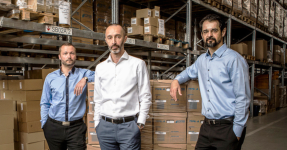 Three men in fron of packaging boxes, Matus Gerek, Michal Helcman, Ondrej Holik (from left to right)