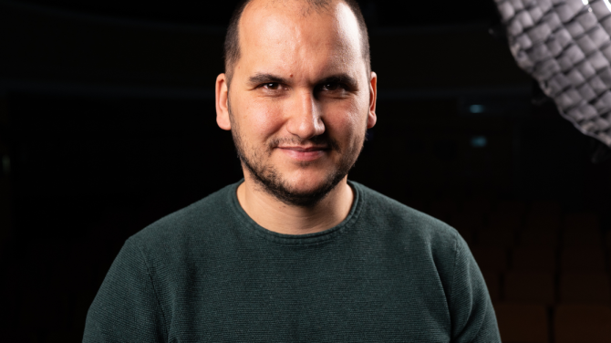 Mihail Dimitrov, founder of Swipe.BG, portrait photo of a male in a sweater, black background