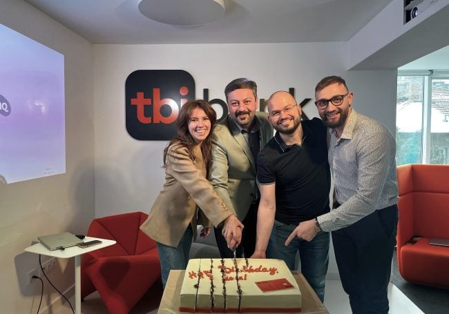 the tbi neon team celebrating the first birthday of the product
