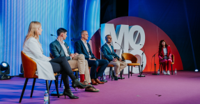 3 men and 2 women on stage in a panel