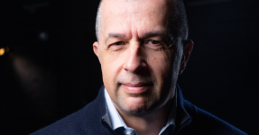 A portrait photo of Dan Mihaescu on a black background