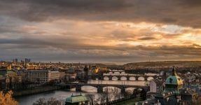 Landscape view of the main bridges of Prague, capital of Czech Republic, during sunset. In the background is the National Theatre.