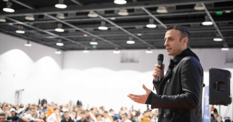 Football Star Dimitar Berbatov speaks in front of a crowd of high school students